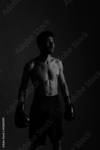 Boxer in darkness with shadows in black and white © Сергей Луговский