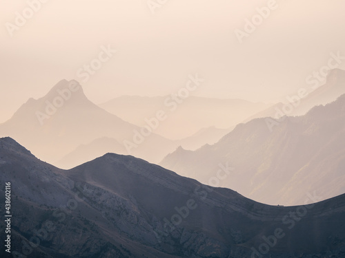 Soft pink sunset in mountain landscape. Amazing pink sunset with a silhouette of mountains.