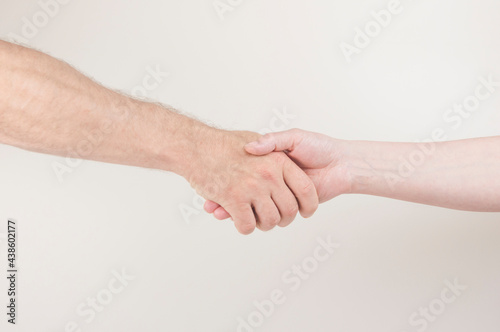 Closeup of shaking hands on bright background