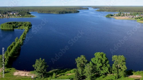 Flight over the taiga forest lake