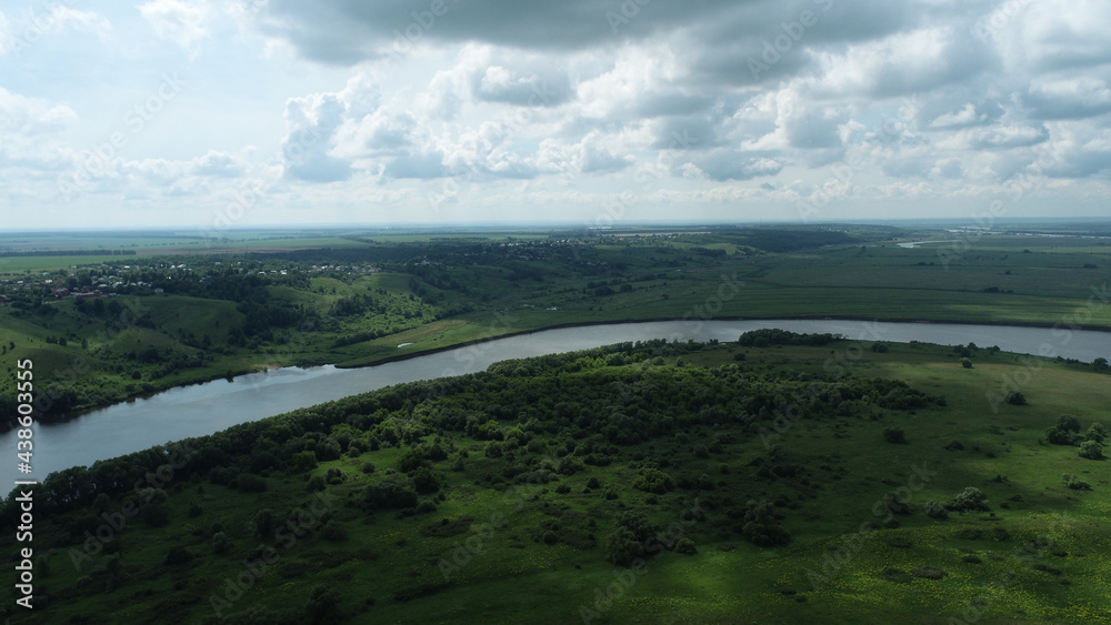 Aerial view of river and floodplains on summer cloudy day