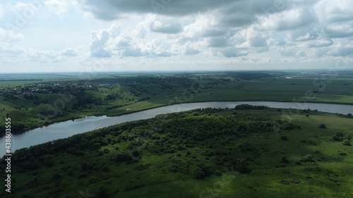 Aerial view of river and floodplains on summer cloudy day