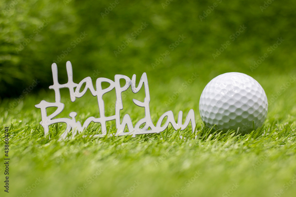 Happy Birthday sign with golf ball are on green grass Photos | Adobe Stock