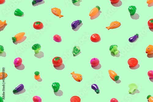 Concept of a healthy lifestyle. Vegetarian food pattern on a light green background.