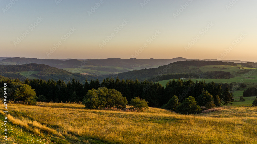 Golden hour at highest point of Rhoen Mountains Wasserkuppe with hilly landscape, Germany