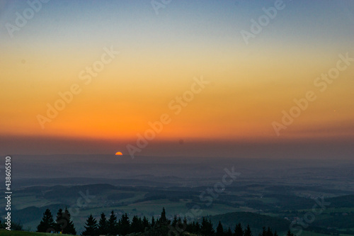 Sunset from Wasserkuppe, the highest point in Roehn Mountains under a clear sky, Germany