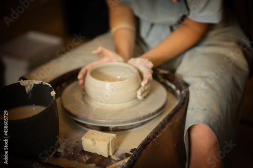 hands make a clay product out of clay on a circle © Марина Верина