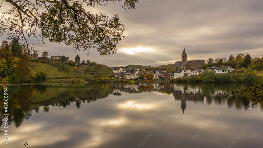 caldera lake with view at city of Ulmen in autumn at evening, Germany