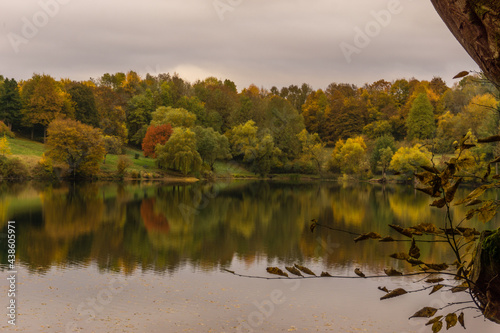 caldera lake of Ulmen with view at colorful forest in autumn, Germany photo