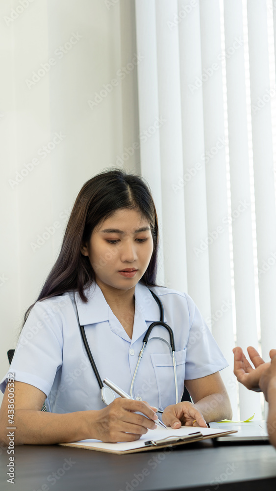 A doctor is writing prescriptions to patients in a medical facility. A doctor is writing prescriptions to patients in a medical facility.