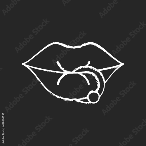 Lip piercing chalk white icon on dark background. Beautiful jewellery type inserted into lip. Metal needles for making professional piercing work. Isolated vector chalkboard illustration on black