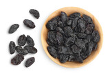 Black raisin iin wooden bowl solated on white background with clipping path. Top view. Flat lay