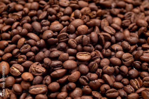 Coffee beans background. Roasted coffee full frame. Texture of dark coffee beans.