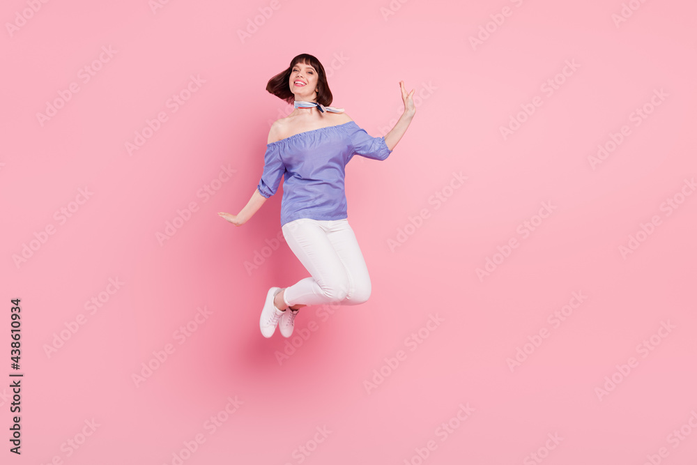 Full length body size photo woman jumping up careless playful isolated pastel pink color background Full length body size photo woman jumping up careless playful isolated pastel pink color background