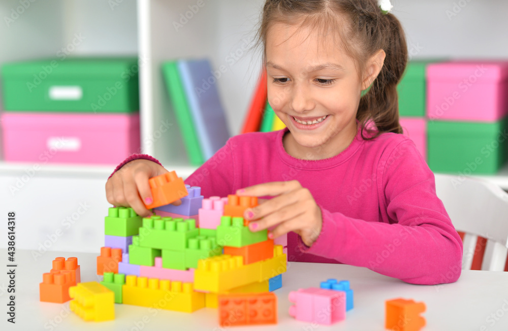 Porait of happy cute little girl playing with cubes Porait of happy cute little girl playing with cubes