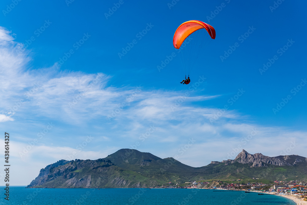 Paragliders against the blue sky.