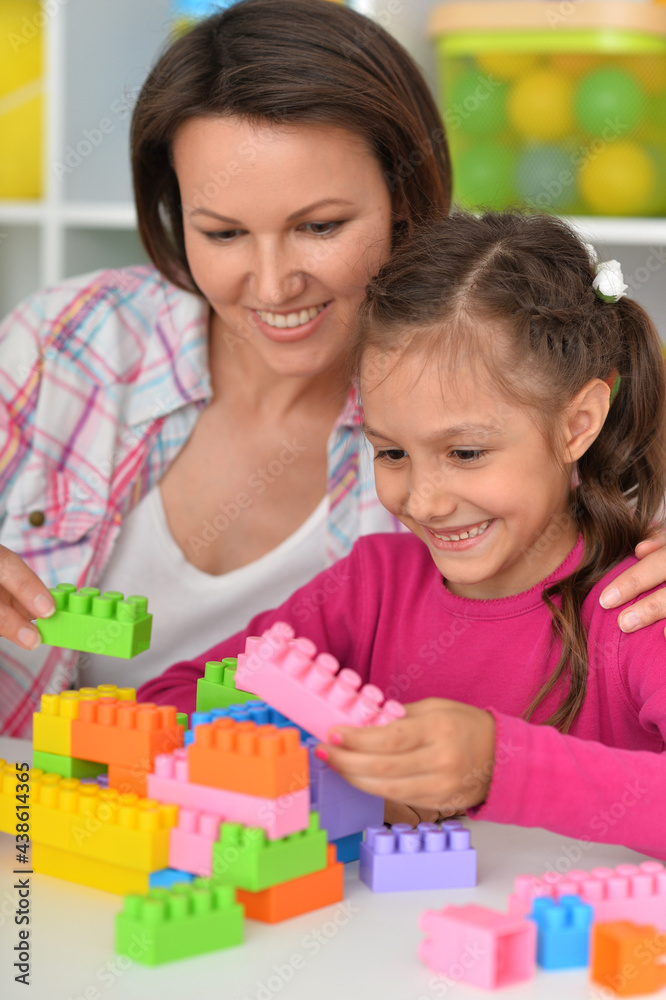 Cute little girl playing with colorful clay blocks at home Cute little girl playing with colorful clay blocks at home