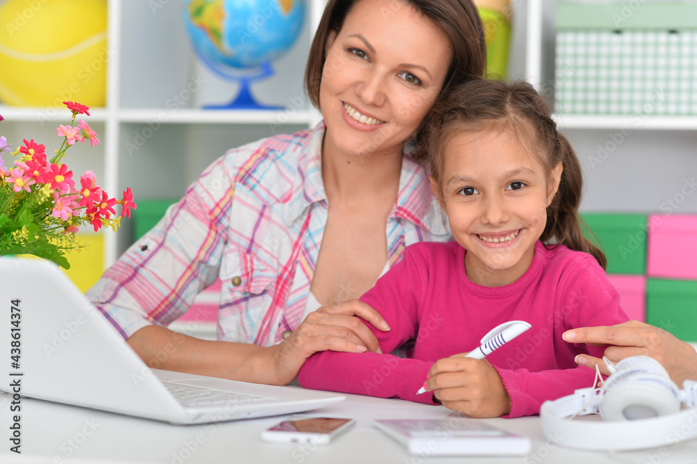 Porait of mother and daughter using laptop Porait of mother and daughter using laptop