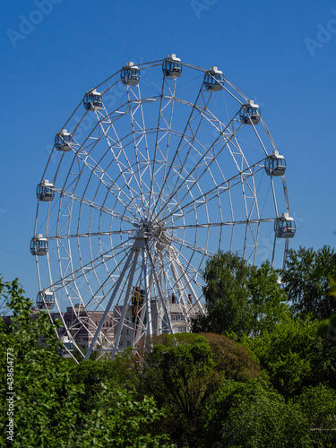 Colorful Ferris wheel in the park on a clear summer day