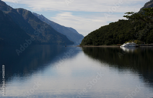 Nahuel Huapi Lake with its reflection  with catamaran moored in Puerto Blest