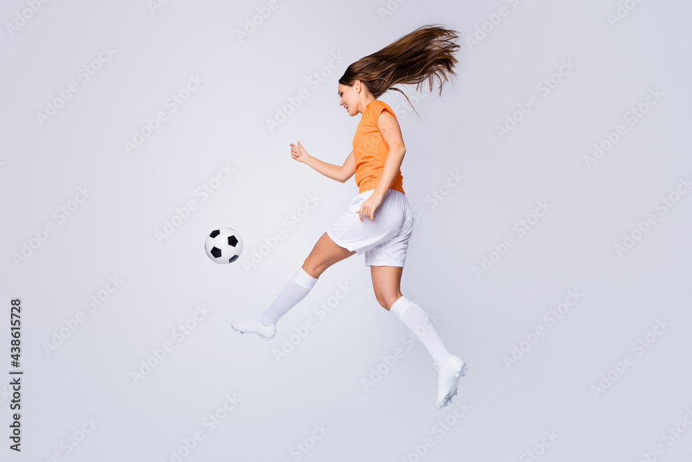 Fototapeta premium Full body profile photo of skilled lady soccer team player euro 2020 league run kick ball final match top scorer wear football t-shirt shorts cleats socks isolated white color background
