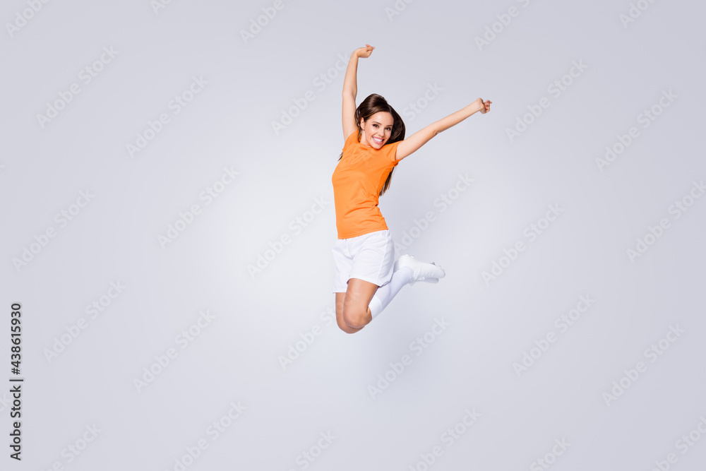 Full length photo of excited lady player soccer team jump up raise fists champion league wear football uniform t-shirt shorts cleats long knee socks isolated white color background
