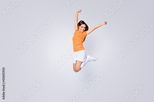 Full length photo of excited lady player soccer team jump up raise fists champion league wear football uniform t-shirt shorts cleats long knee socks isolated white color background