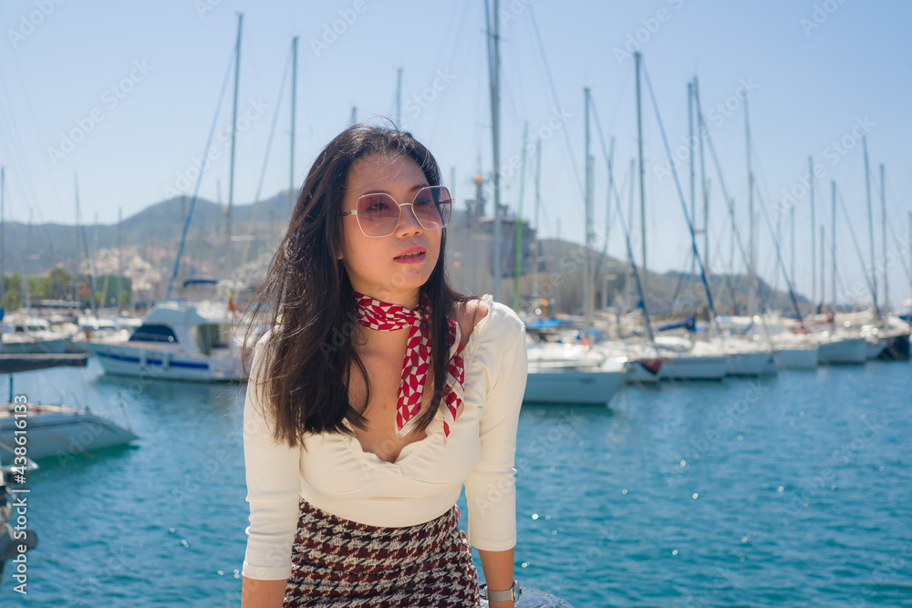 attractive Asian woman at the sea - lifestyle holidays portrait of young beautiful and happy Chinese tourist girl on harbor enjoying sailing club enjoying Summer vacation