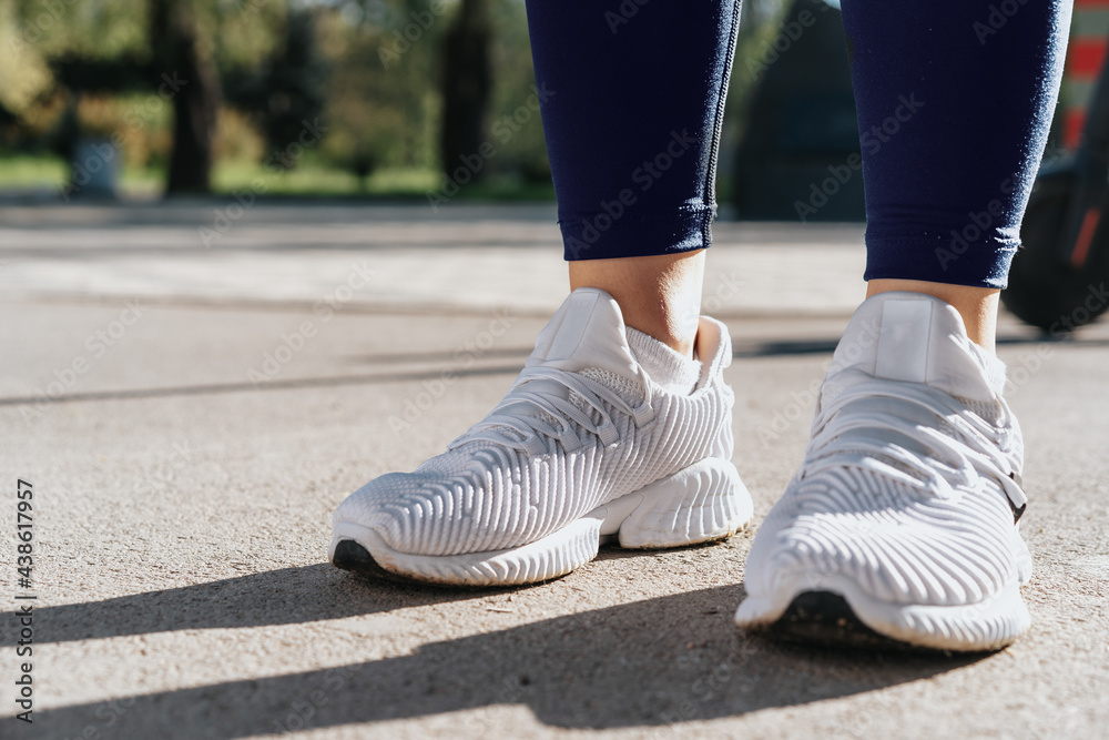 Feet of a woman dressed in sportswear and sneakers for running