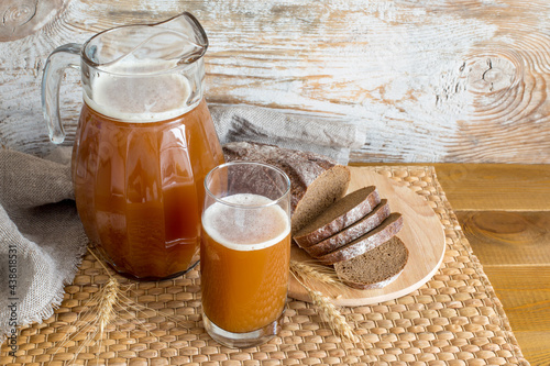 A jug and a glass of homemade bread kvass.