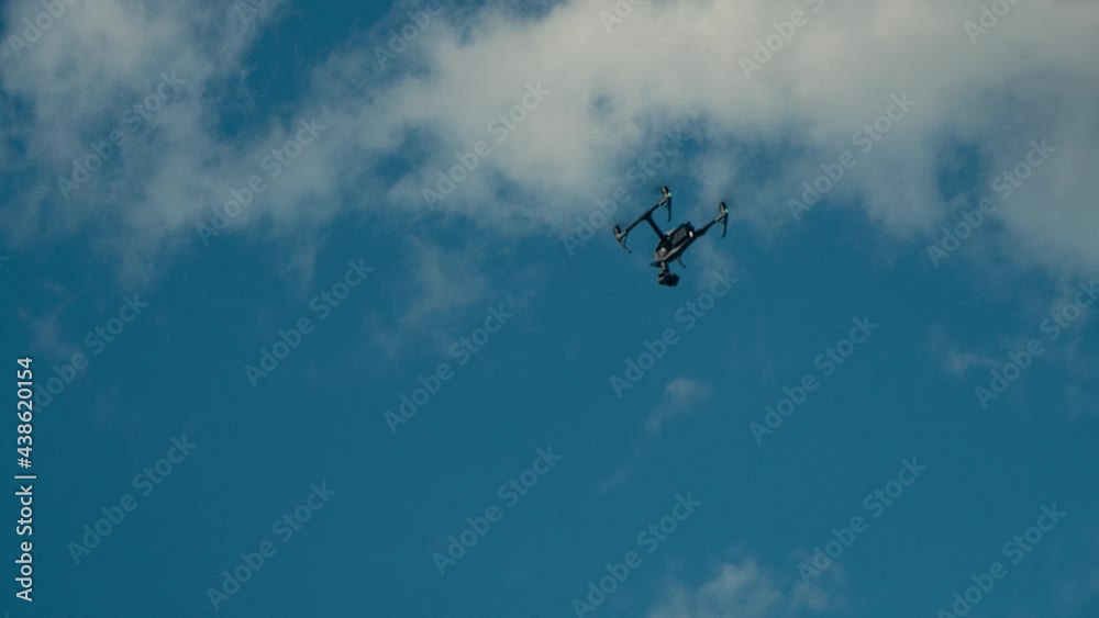 Copter Or Drone Flies Against The Blue Sky Copter Or Drone Flies Against The Blue Sky