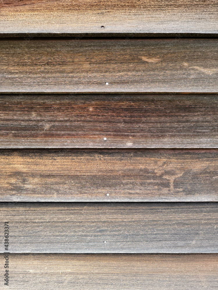 Old cedar clapboard siding worn by the elements. Stock Photo Adobe Stock