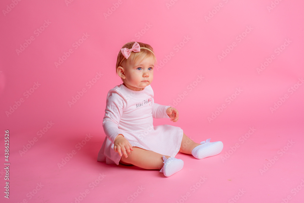 cute little baby girl in pink summer dress sitting on pink background cute little baby girl in pink summer dress sitting on pink background