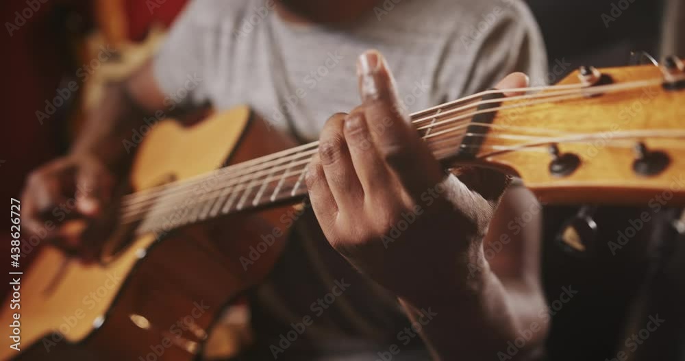 Black musician playing acoustic guitar Black musician playing acoustic guitar