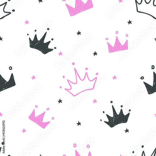 Hand drawn seamless pattern with doodle crowns. Cute baby and little princess design. Children's room wallpaper and clothes texture.