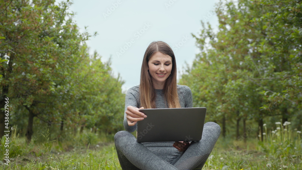 IT specialist working at self isolation outdoors. Women engaging in business or freelance at nature or fresh air at amazing sun light. Girl sitting in park or forest, opening laptop on nature. IT specialist working at self isolation outdoors. Women engaging in business or freelance at nature or fresh air at amazing sun light. Girl sitting in park or forest, opening laptop on nature.
