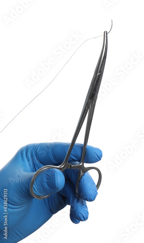 Doctor holding forceps with suture thread on white background, closeup. Medical equipment photo