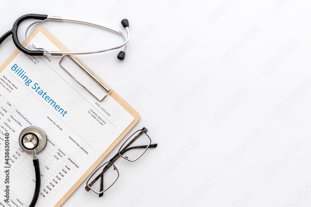 Medical billing statement with stethoscope. Top view Medical billing statement with stethoscope. Top view