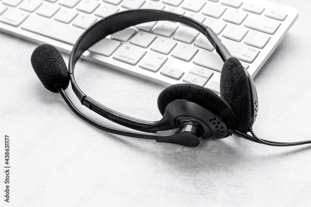 Voip headset and computer laptop on offise desk. Commenication it support call center Voip headset and computer laptop on offise desk. Commenication it support call center