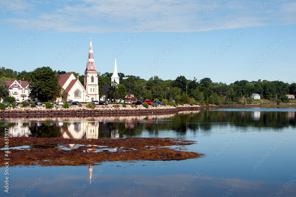 Picturesque church reflecting in waters on maritime coast