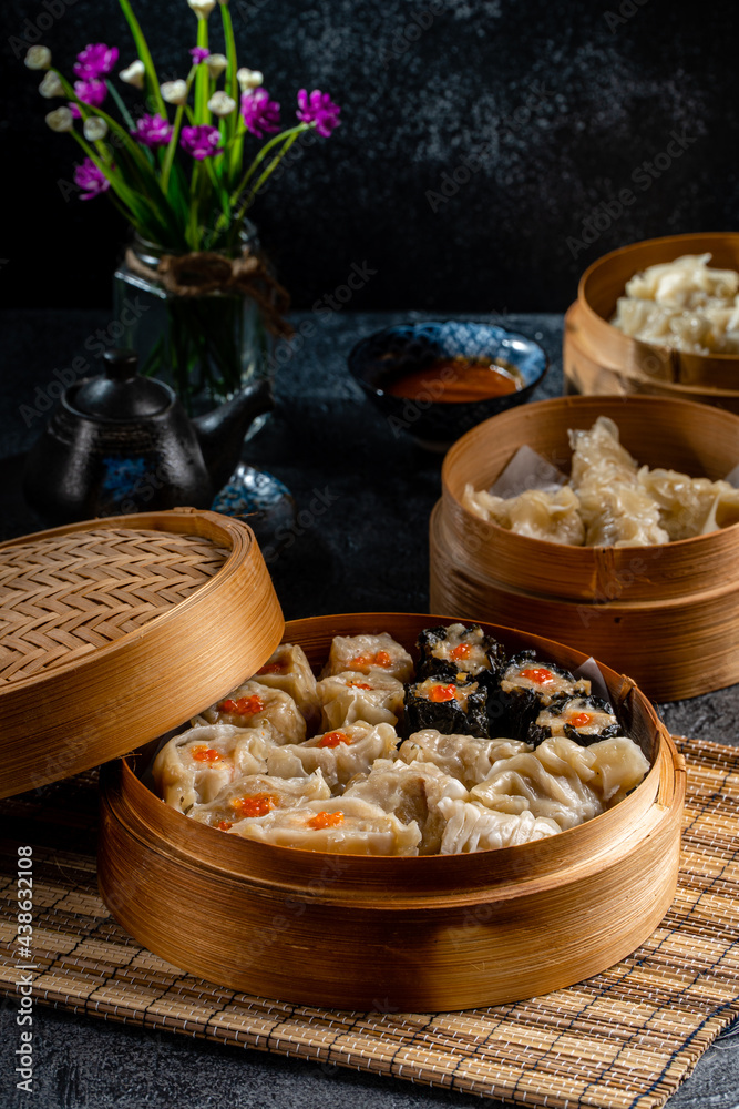 Assorted Chinese Dimsum in bamboo basket. Dimsum is a large range of small dishes that Cantonese people traditionally enjoy in restaurants for breakfast and lunch. Assorted Chinese Dimsum in bamboo basket. Dimsum is a large range of small dishes that Cantonese people traditionally enjoy in restaurants for breakfast and lunch.