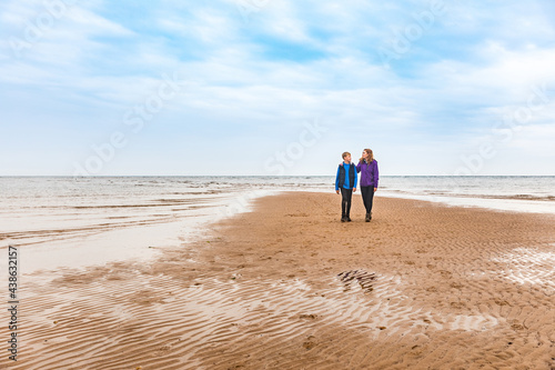 Boy and woman at beach on a rainy day