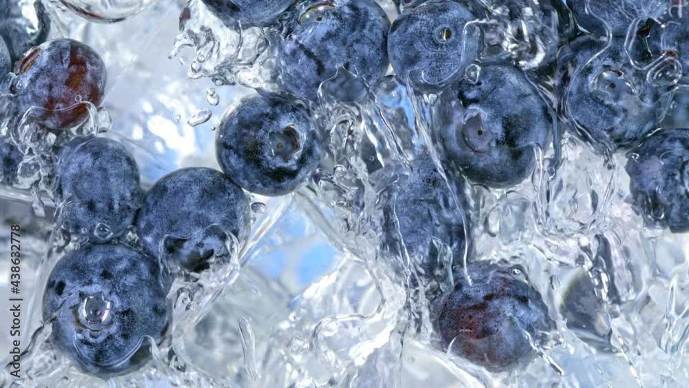 Super Slow Motion Shot of Pouring Water on Blueberries and Ice Cubes in Glass at 1000 fps. Super Slow Motion Shot of Pouring Water on Blueberries and Ice Cubes in Glass at 1000 fps.
