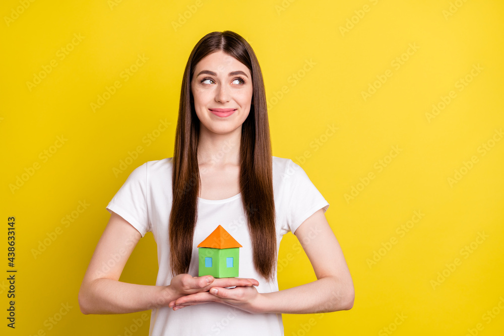 Photo of young girl happy positive smile hold home house figure dream new real estate isolated over yellow color background Photo of young girl happy positive smile hold home house figure dream new real estate isolated over yellow color background
