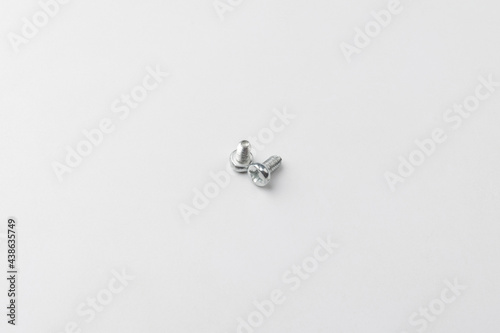 small iron screws on a white background