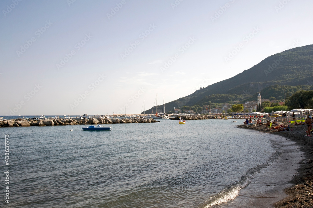 Breakwater and mole with the mount Bulgheria in the background at sunset. Scario village in the Policastro gulf, Salerno, Italy, Europe