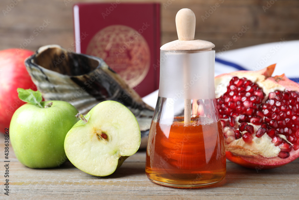 Honey, pomegranate, apples, shofar and Torah on wooden table. Rosh Hashana holiday Honey, pomegranate, apples, shofar and Torah on wooden table. Rosh Hashana holiday