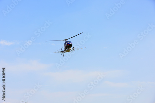 Agricultural helicopters for controlling Hyphantria cunea spray pesticides over the city
