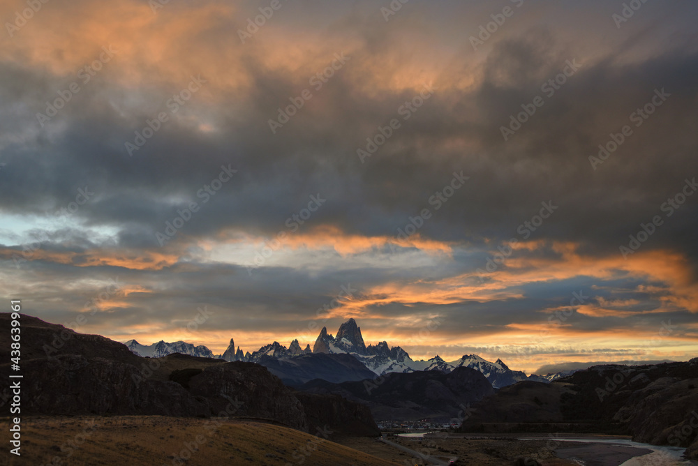 The road approaching the town of El Chalten with famous Patagonia mountains in the background at golden hour