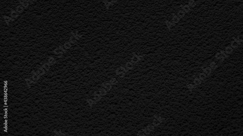 special black spray painted to create grungy plaster concrete texture, close-up texture background for architectural building facade. rough grained cement wall background.